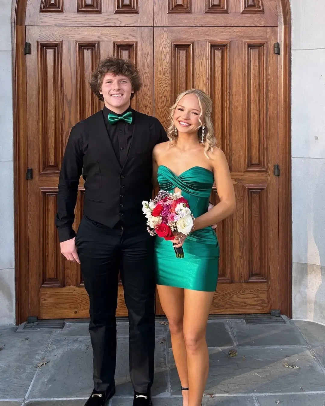poffie girl wearing green homecoming  dress, with guy wearing black suit