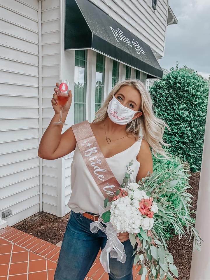 Woman with blonde hair posing outside of bridal boutique